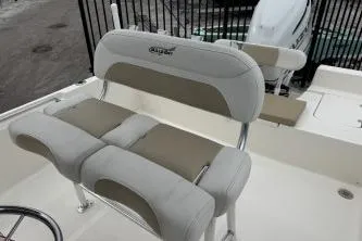 Slide: The Image of 2023 Bulls Bay 2400 boat seating with cushioned bench and steering wheel. - 12