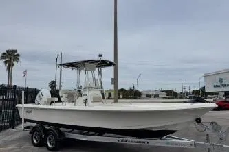 Slide: The Image of 2023 Bulls Bay 2400 boat on trailer, parked outdoors near dealership. - 2