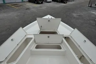 Slide: The Image of 2023 Bulls Bay 2400 boat with open storage compartments on deck. - 7