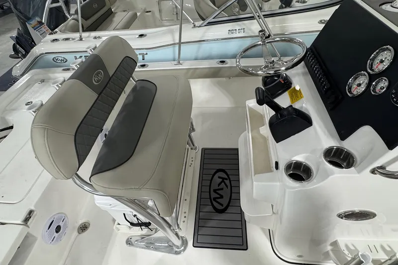 Slide: The Image of 2026 Key West 210 Bay Reef boat interior with steering console and seating. - 11