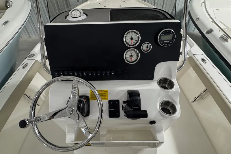 Slide: The Image of 2026 Key West 210 Bay Reef boat console with steering wheel and gauges. - 12