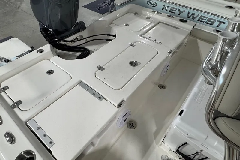 Slide: The Image of 2026 Key West 210 Bay Reef boat interior with storage compartments and seating. - 13