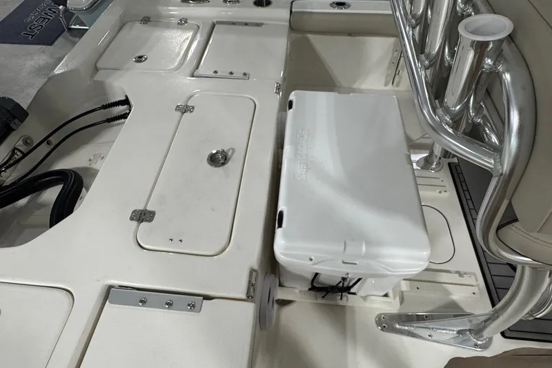 Slide: The Image of 2026 Key West 210 Bay Reef boat interior with storage compartments and seating. - 14