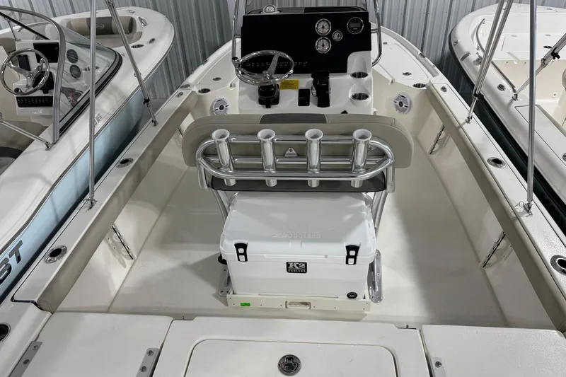 Slide: The Image of 2026 Key West 210 Bay Reef boat interior with steering console and rod holders. - 3