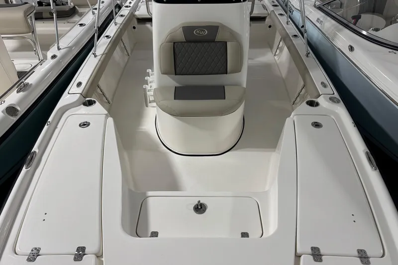 Slide: The Image of 2026 Key West 210 Bay Reef boat interior with seating and storage compartments. - 4