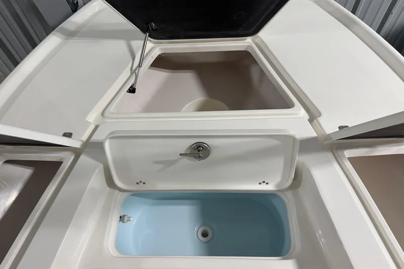 Slide: The Image of 2026 Key West 210 Bay Reef boat storage compartments and livewell, open view. - 6