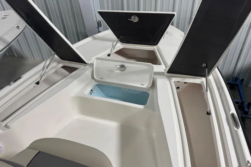 Slide: The Image of 2026 Key West 210 Bay Reef boat with open storage compartments and seating area. - 7