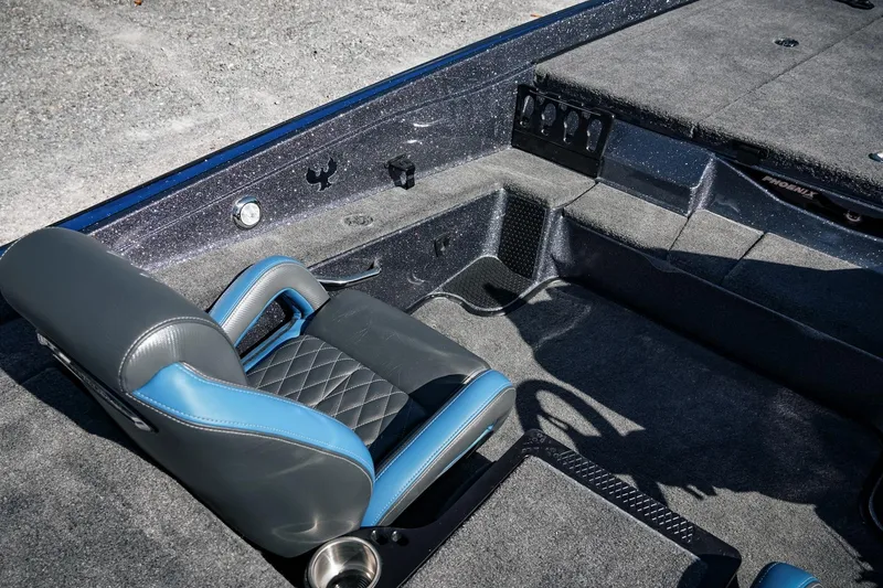 Slide: The Image of 2026 Phoenix 721 ZXL boat interior with gray and blue seating, carpeted flooring. - 19