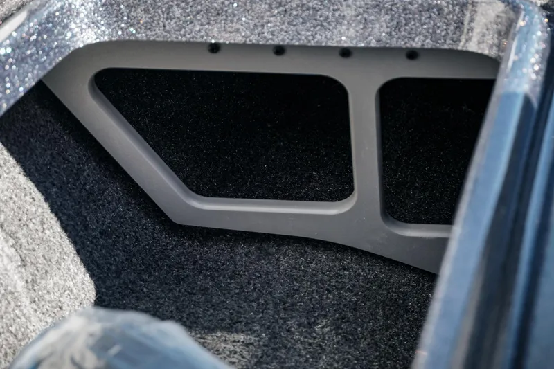 Slide: The Image of Interior compartment of 2026 Phoenix 721 ZXL boat, featuring carpeted storage space. - 24