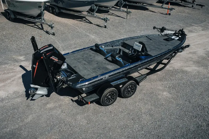 Slide: The Image of 2026 Phoenix 721 ZXL bass boat on trailer, parked on gravel lot. - 3