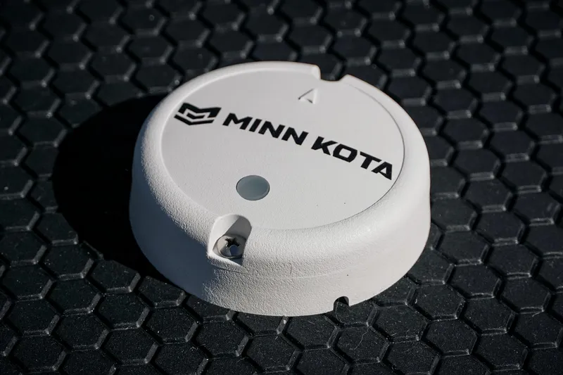 Slide: The Image of Minn Kota device on Phoenix 721 ZXL 2026 boat with hexagonal pattern background. - 30