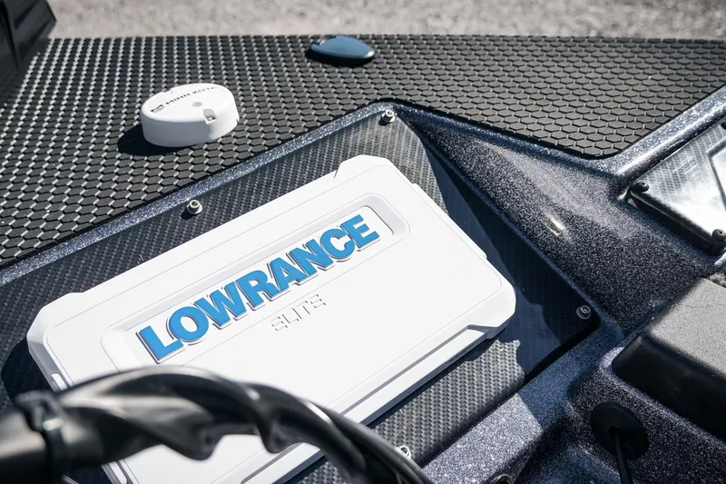 Slide: The Image of Lowrance Elite device on 2026 Phoenix 721 ZXL boat dashboard with textured surface. - 31