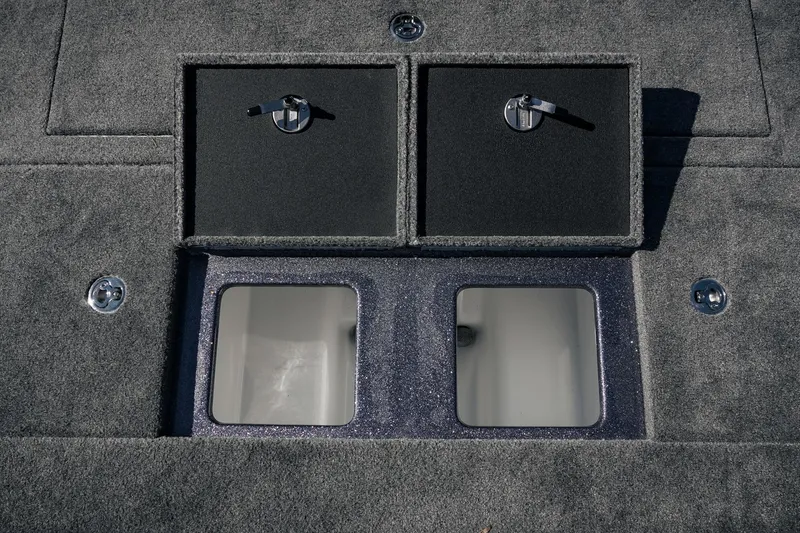 Slide: The Image of 2026 Phoenix 721 ZXL boat storage compartments with secure latches and carpeted finish. - 33