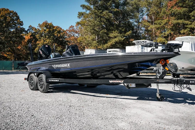 Slide: The Image of 2026 Phoenix 721 ZXL boat on trailer, parked outdoors with autumn trees in background. - 8