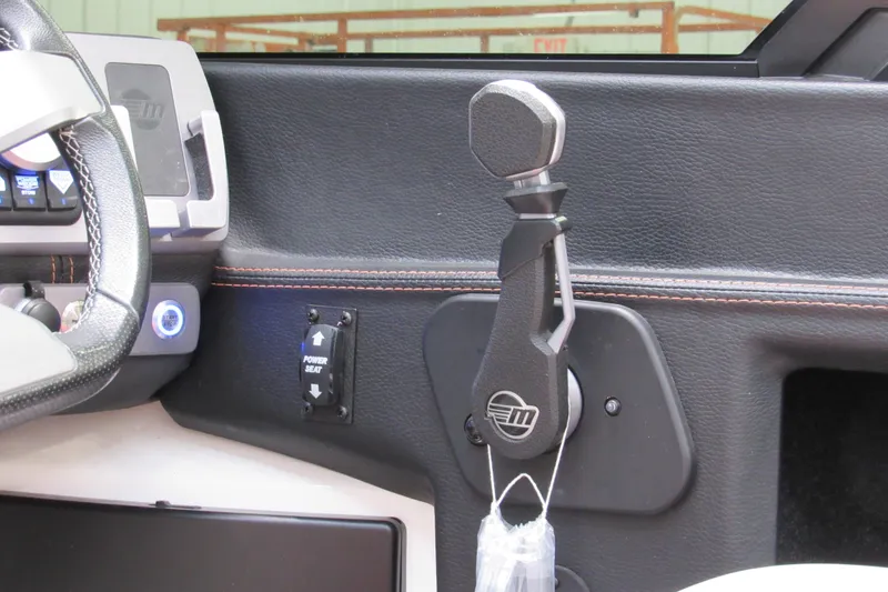 Slide: The Image of 2021 Malibu Wakesetter 24 MXZ interior, featuring steering wheel and control lever. - 13