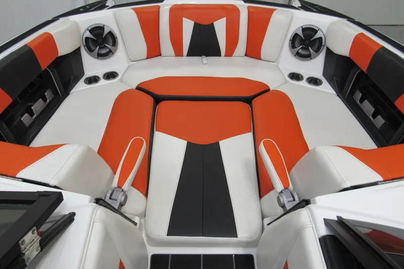 Slide: The Image of 2021 Malibu Wakesetter 24 MXZ interior with orange, black, and white seating. - 16