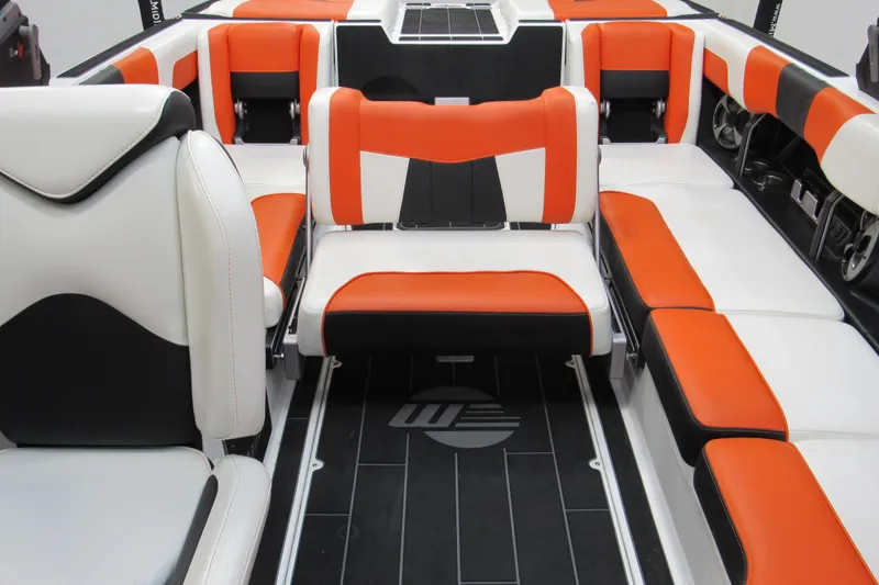 Slide: The Image of 2021 Malibu Wakesetter 24 MXZ interior with orange, black, and white seating. - 18