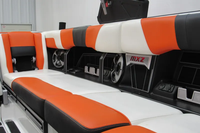 Slide: The Image of 2021 Malibu Wakesetter 24 MXZ interior with orange and white seating. - 19
