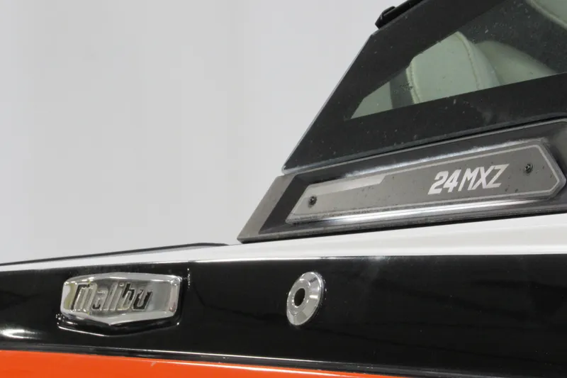 Slide: The Image of 2021 Malibu Wakesetter 24 MXZ boat, close-up of branding and model details. - 23
