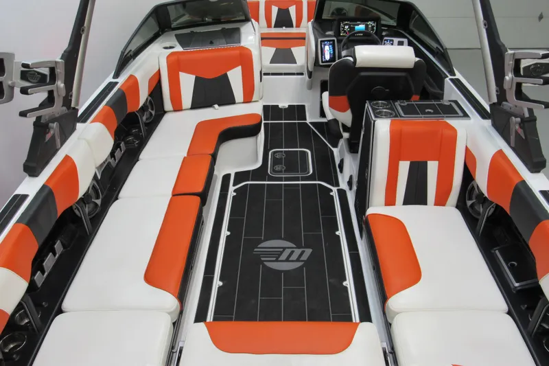 Slide: The Image of 2021 Malibu Wakesetter 24 MXZ interior with orange and white seating, modern dashboard. - 5