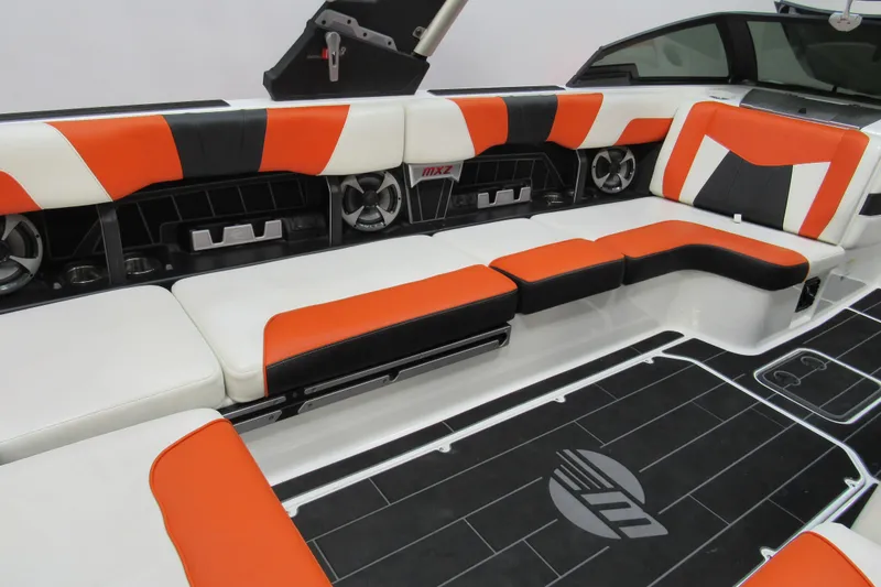 Slide: The Image of 2021 Malibu Wakesetter 24 MXZ interior with orange, black, and white seating. - 9