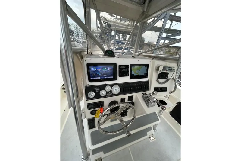 Slide: The Image of 2002 Shamrock 270 Open boat dashboard with navigation screens and controls. - 11