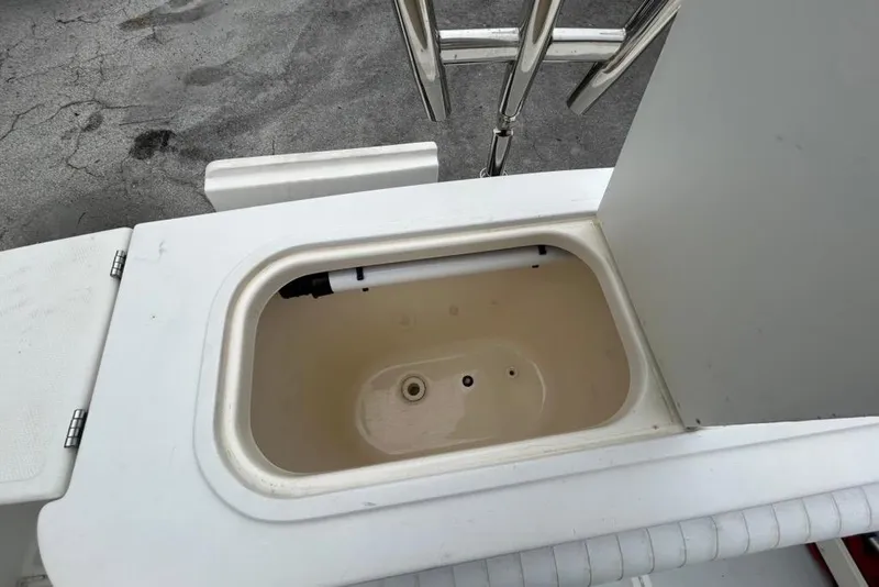 Slide: The Image of Open storage compartment on 2002 Shamrock 270 Open boat deck. - 15