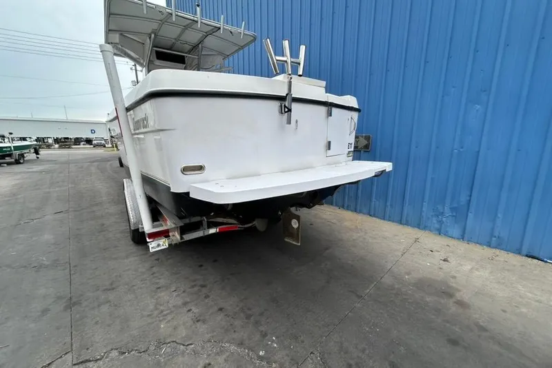 Slide: The Image of 2002 Shamrock 270 Open boat on trailer, parked by blue wall. - 5