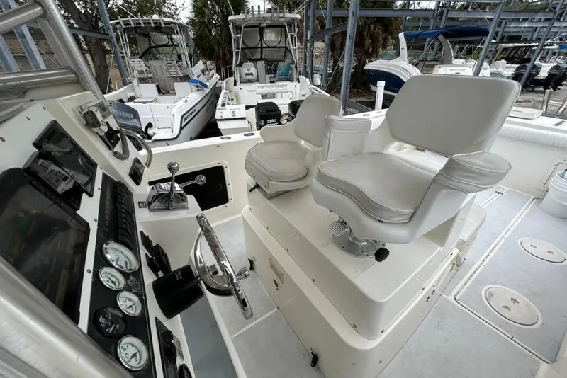 Slide: The Image of 2002 Shamrock 270 Open boat interior with dual captain chairs and control panel. - 7