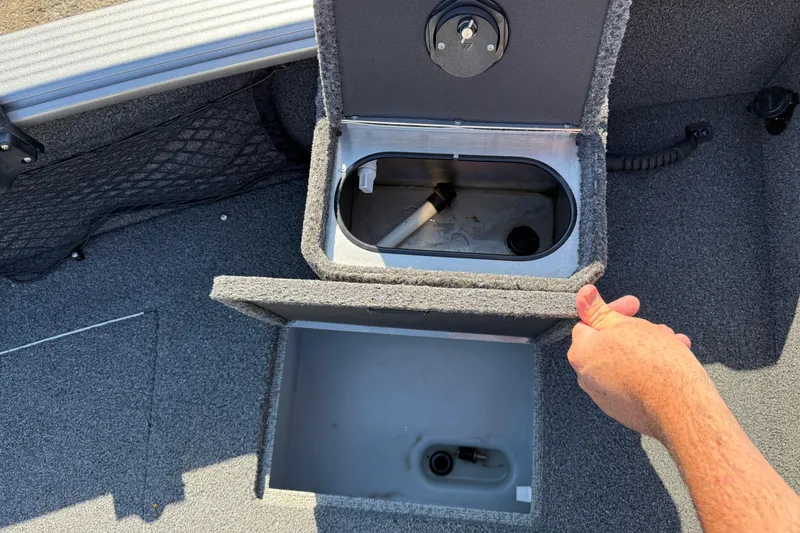 Slide: The Image of 2019 Lund 2025 Impact XS boat storage compartments with open lids. - 11