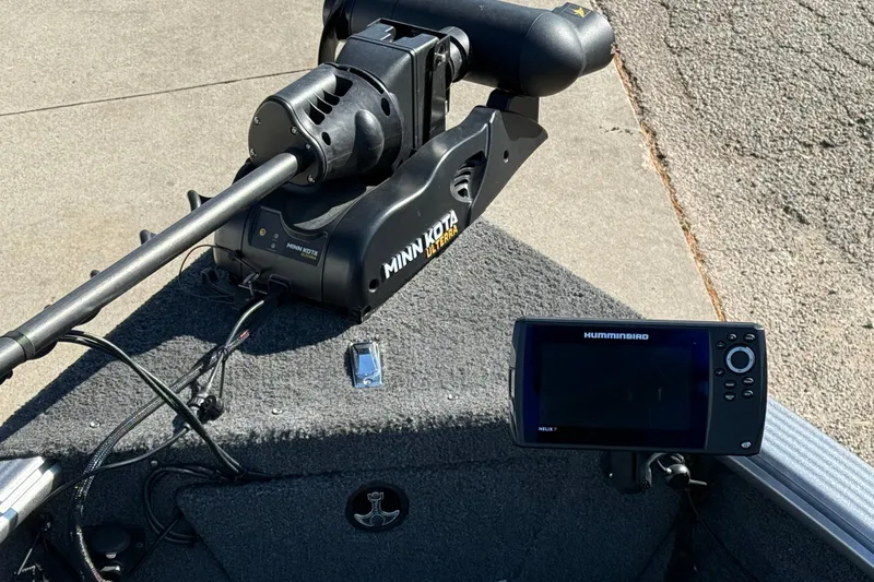 Slide: The Image of 2019 Lund 2025 Impact XS boat with Minn Kota trolling motor and Humminbird Helix 7 fish finder. - 13