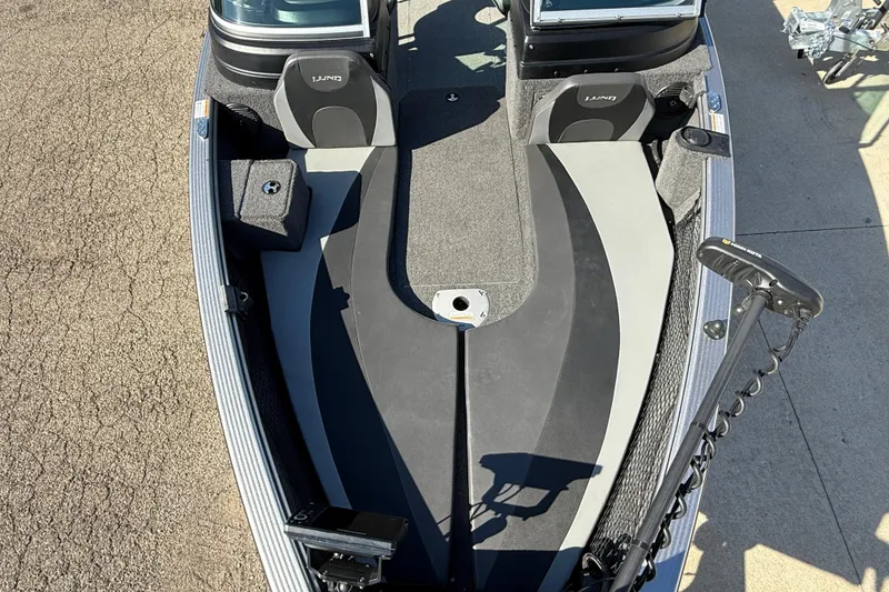 Slide: The Image of 2019 Lund 2025 Impact XS boat interior with seating and fishing equipment. - 14