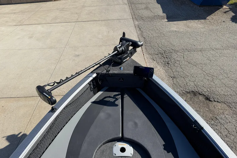 Slide: The Image of 2019 Lund 2025 Impact XS boat with trolling motor on concrete surface. - 15