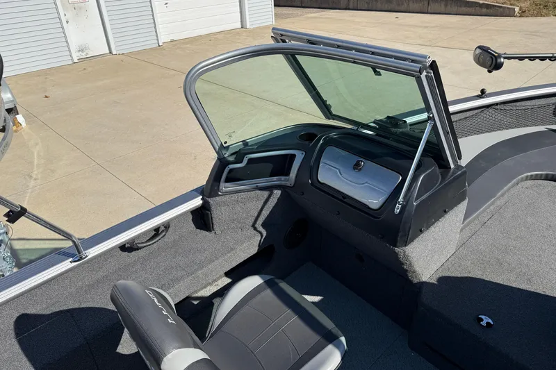 Slide: The Image of 2019 Lund 2025 Impact XS boat interior with seating and console. - 25