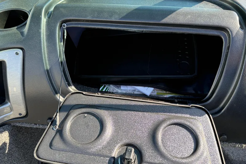 Slide: The Image of 2019 Lund 2025 Impact XS boat storage compartment open, showing interior details. - 26