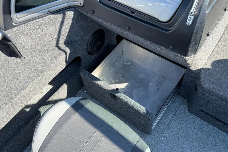 Slide: The Image of 2019 Lund 2025 Impact XS boat interior with open storage compartment. - 27