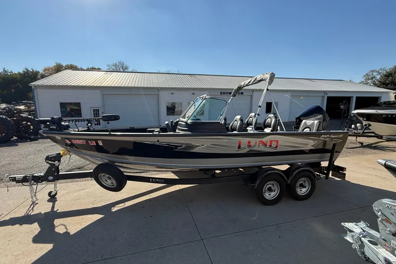 Slide: The Image of 2019 Lund 2025 Impact XS boat on trailer outside showroom. - 3