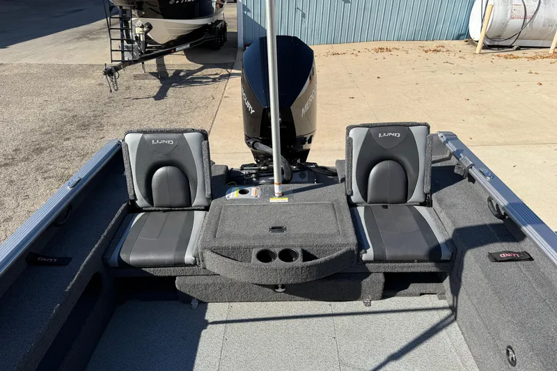 Slide: The Image of 2019 Lund 2025 Impact XS boat interior with seating and Mercury engine. - 31