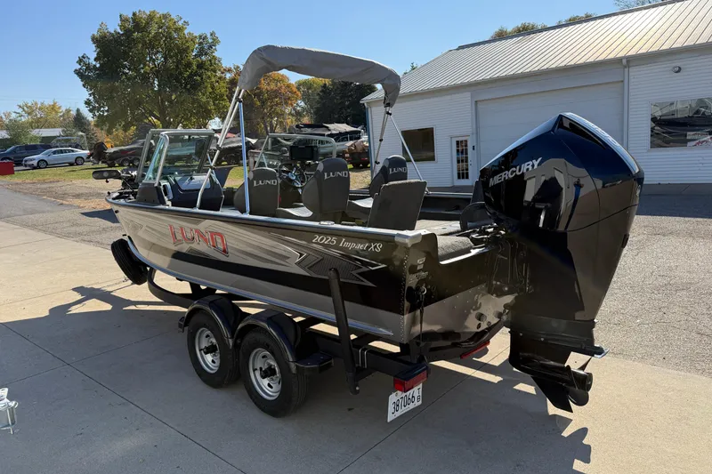 Slide: The Image of 2019 Lund 2025 Impact XS boat with Mercury engine on trailer. - 4