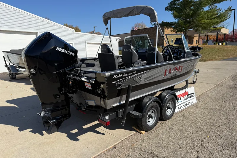 Slide: The Image of 2019 Lund 2025 Impact XS boat with Mercury engine on trailer. - 6