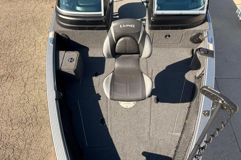 Slide: The Image of 2019 Lund 2025 Impact XS boat interior with seating and fishing equipment. - 7