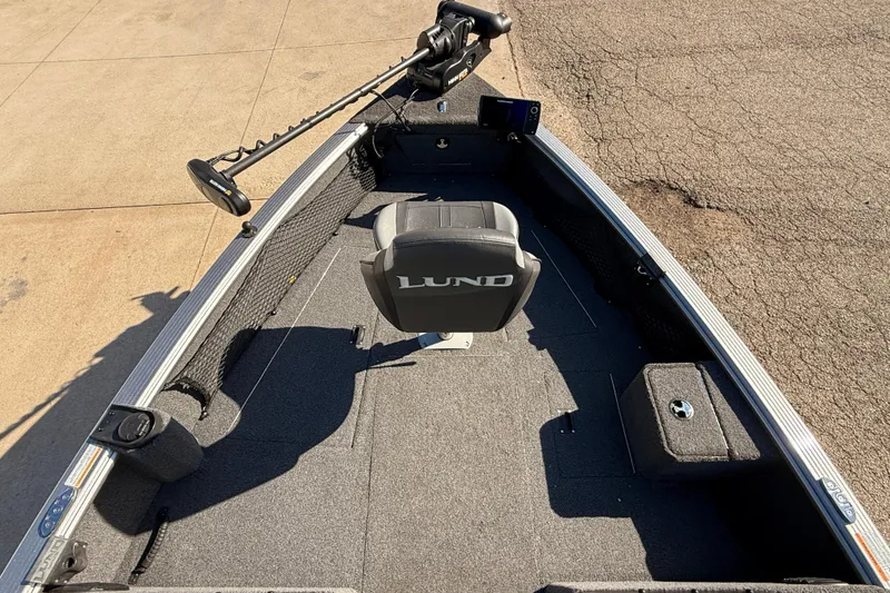 Slide: The Image of 2019 Lund 2025 Impact XS boat interior with seating and trolling motor. - 8