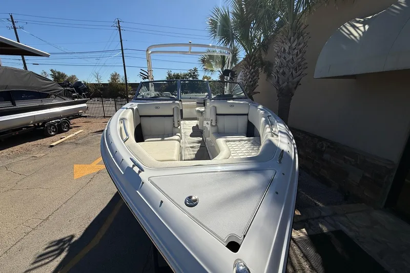 Slide: The Image of 2018 Cobalt R7 Surf boat with sleek design, parked outdoors under clear sky. - 3