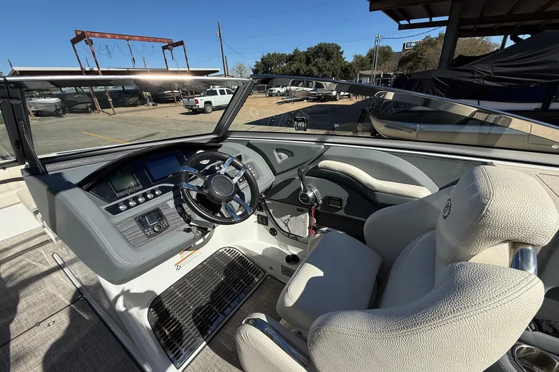Slide: The Image of 2018 Cobalt R7 Surf boat interior with steering wheel and dashboard controls. - 8