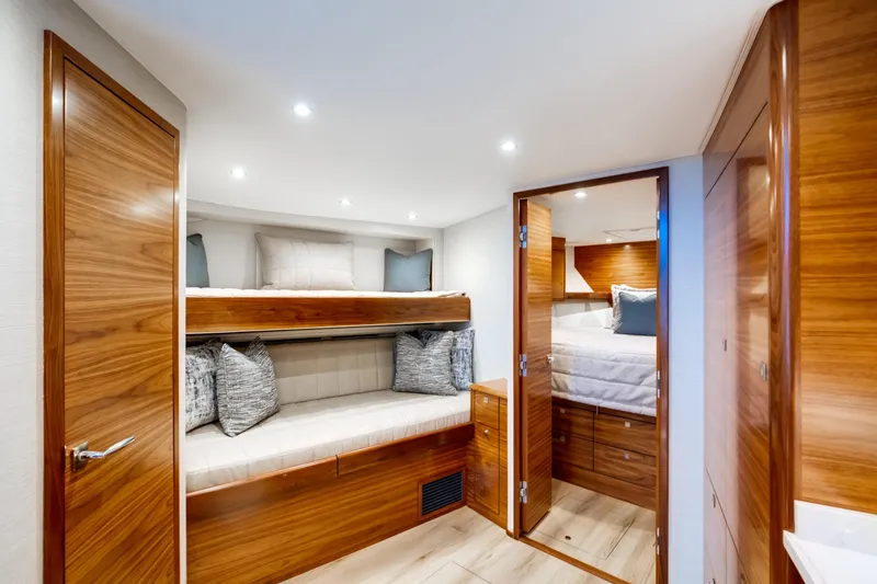 Slide: The Image of Luxurious interior of 2026 Viking 46 Billfish yacht with wooden finishes and cozy bedding. - 15