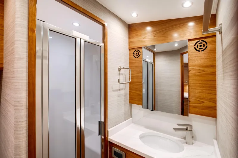 Slide: The Image of Luxurious bathroom in 2026 Viking 46 Billfish yacht with modern fixtures and wood accents. - 16