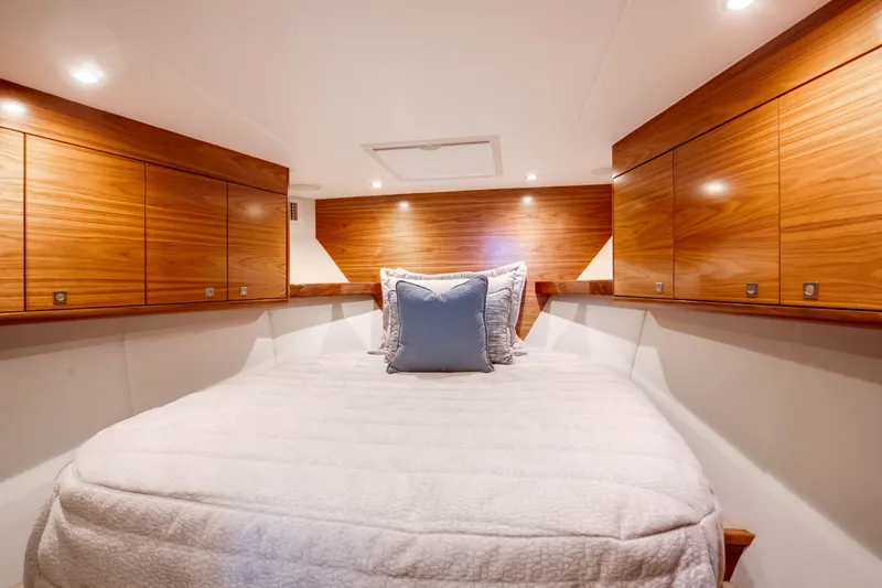 Slide: The Image of Luxurious cabin interior of 2026 Viking 46 Billfish yacht with wooden cabinetry and cozy bedding. - 17
