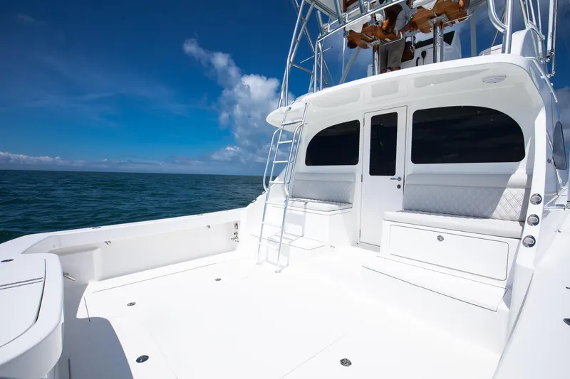Slide: The Image of 2026 Viking 46 Billfish yacht deck with seating, ladder, and ocean view. - 18
