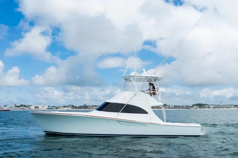 Slide: The Image of 2026 Viking 46 Billfish yacht cruising on open water under a cloudy sky. - 3