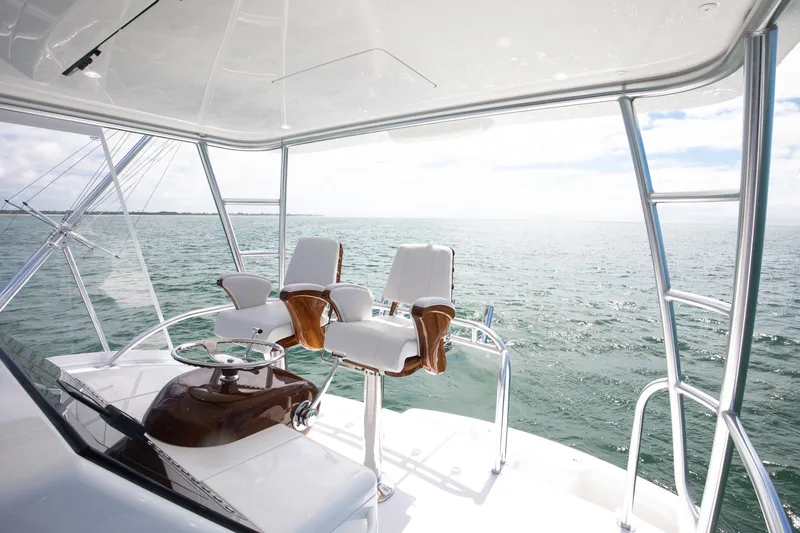 Slide: The Image of Flybridge of 2026 Viking 46 Billfish yacht with ocean view and helm chairs. - 9